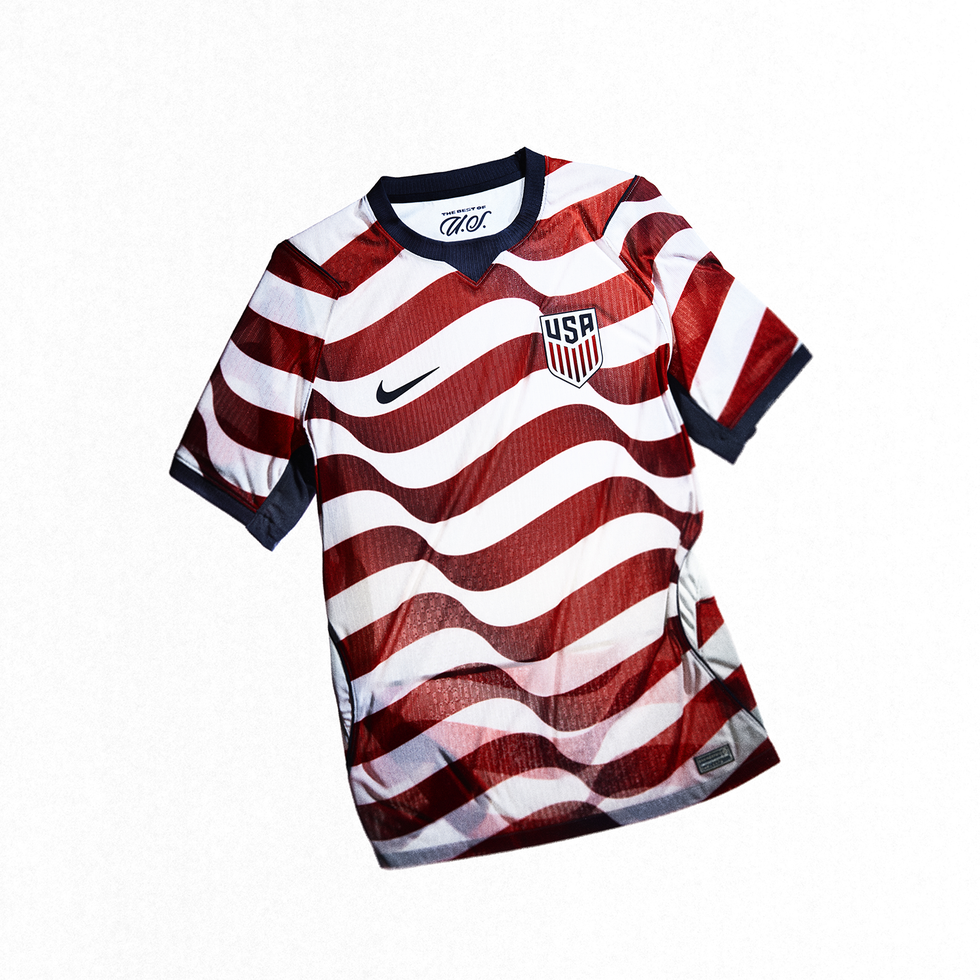 a red and white striped soccer jersey with a logo