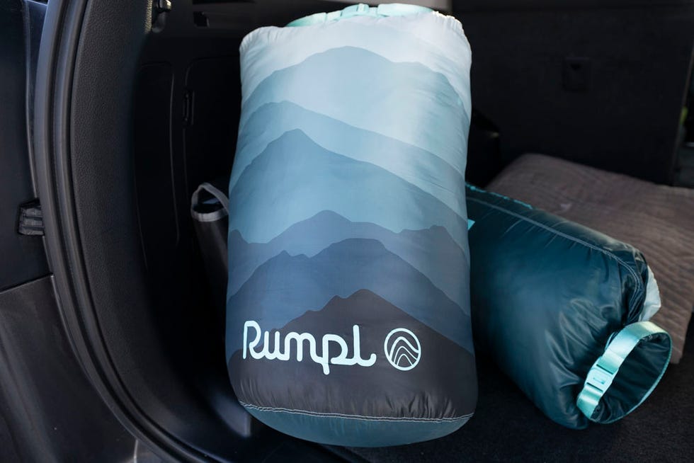 Rumpl Wrap Sack and Rumpl Camp Pillow in stuff sacks inside an SUV.