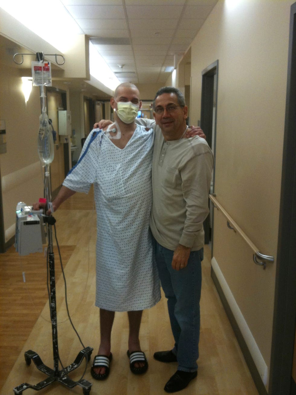 Hospital corridor with David in a hospital gown, and his dad.