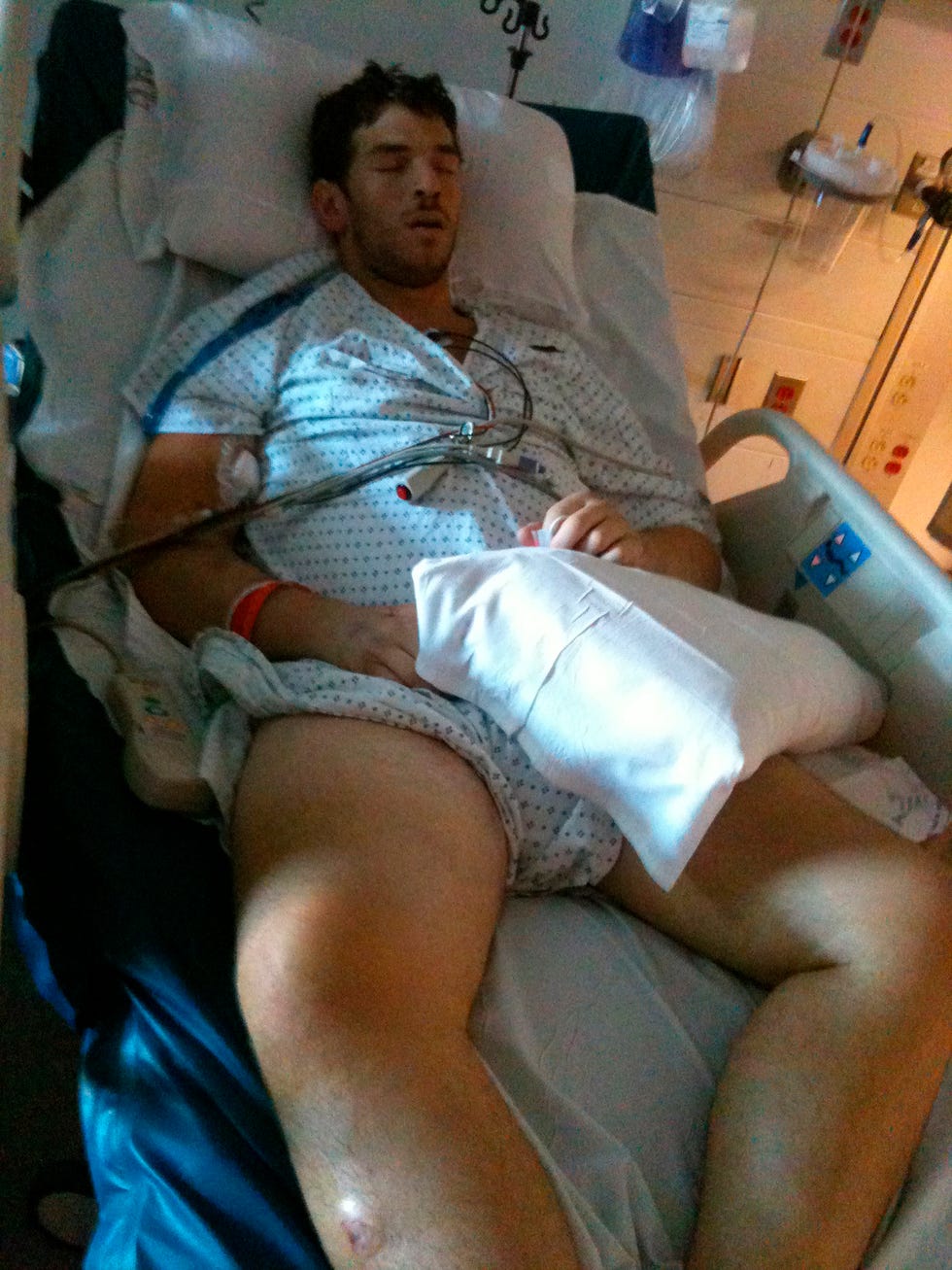 Patient resting in a hospital bed with medical equipment nearby.