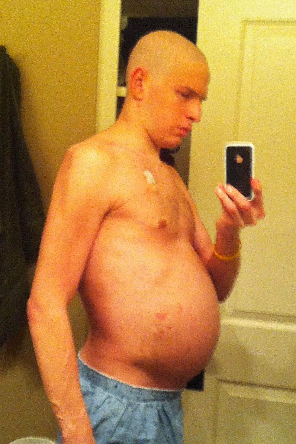 A person taking a mirror selfie showing their upper body.