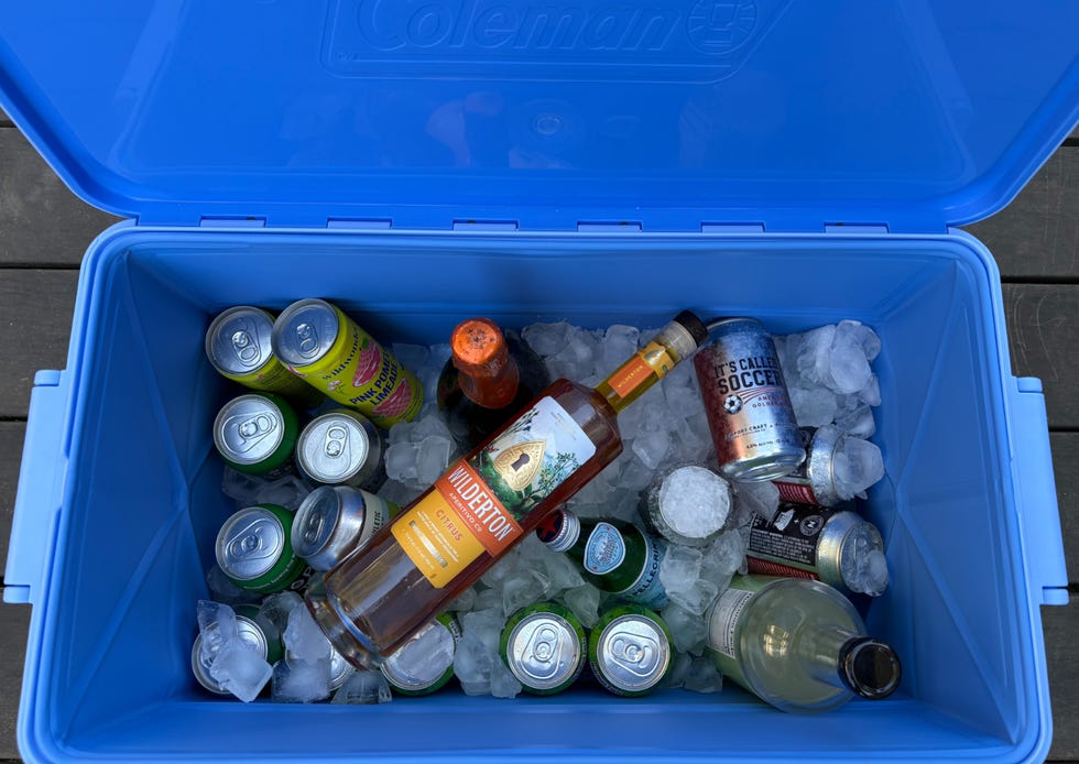 A cooler filled with various beverages and ice.