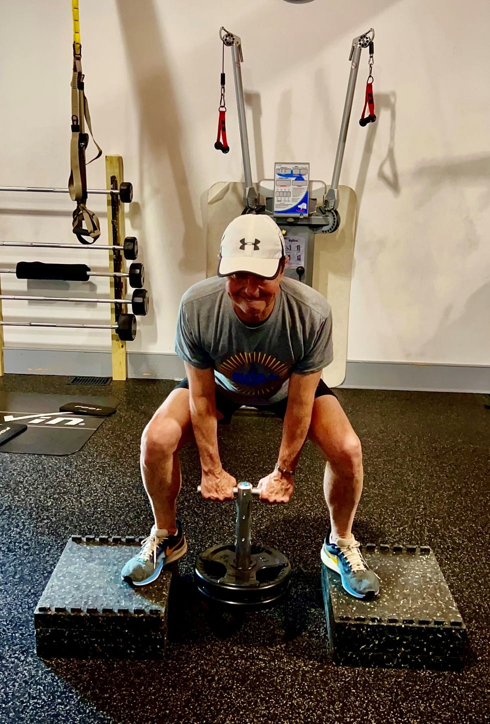 Individual performing a weightlifting exercise.