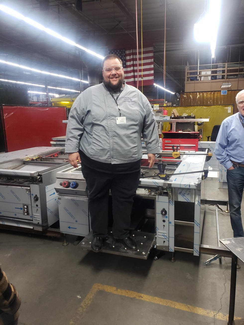 Gary Biser standing on industrial kitchen equipment