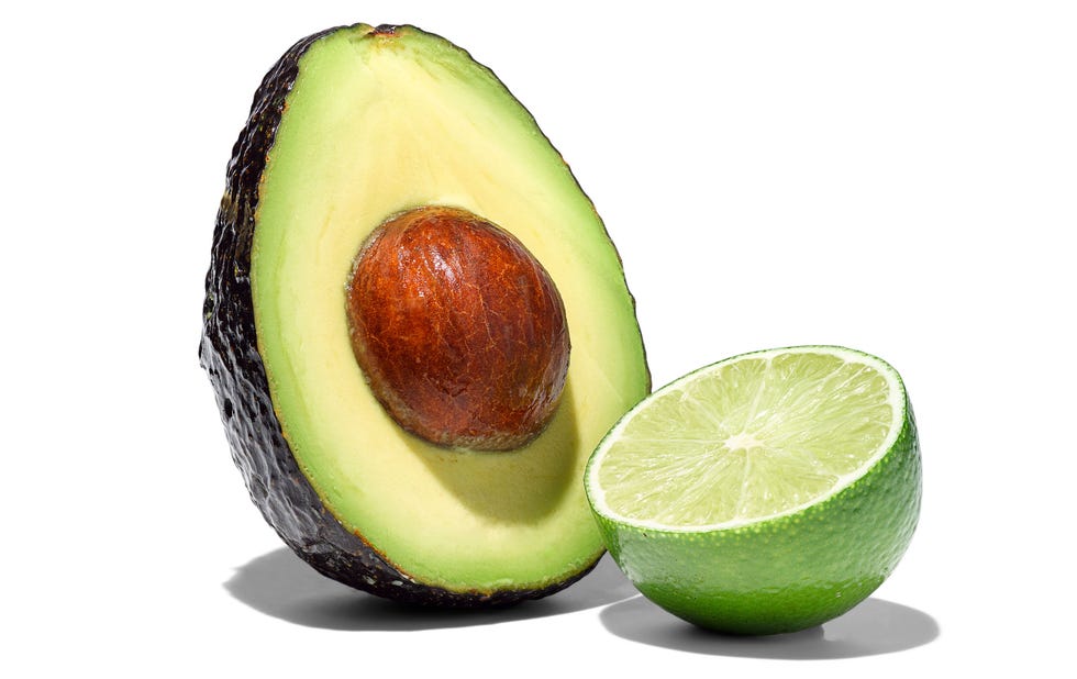 avocado half with pit and lime