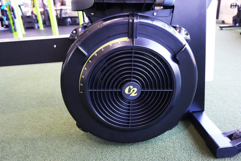 Close-up of the flywheel on a rowing machine, featuring speed and resistance indicators.