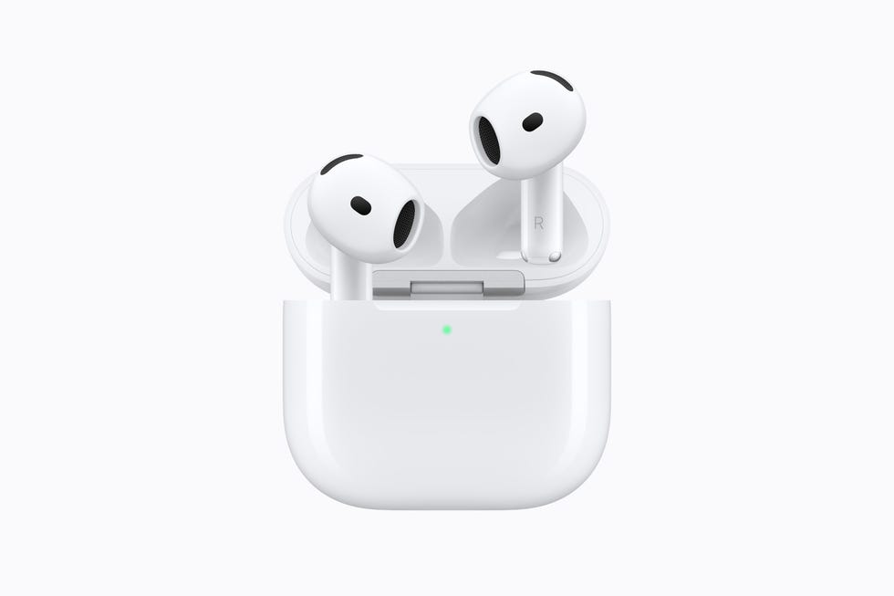 Wireless earbuds in charging case with a green indicator light. Wireless earbuds in charging case with a green indicator light.